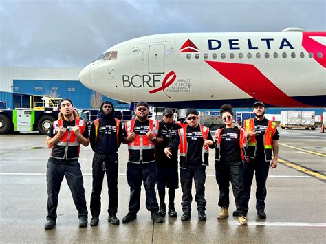 delta ground crew preparing aircraft at mco on saturday morning
