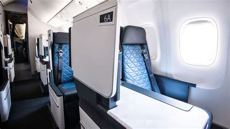 Delta One cabin interior with lie-flat seats and ambient lighting