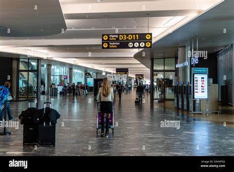 Departure hall at Oslo Airport Gardermoen with passengers and flight displays