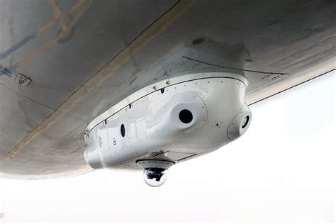 DIRCM laser turret close-up installed on military aircraft fuselage