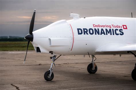 Dronamics Black Swan cargo drone in mid-flight over rural logistics route