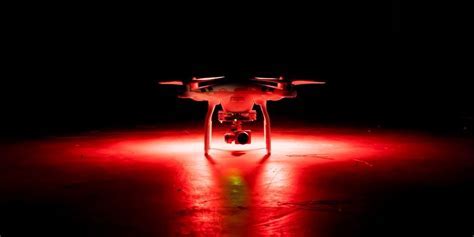 drone pilot flying at night with anti-collision lights
