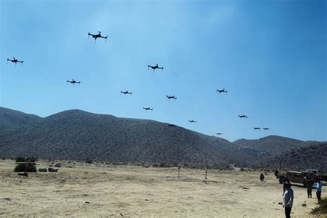 Drone swarm conducting military training exercise in Nevada desert 2025
