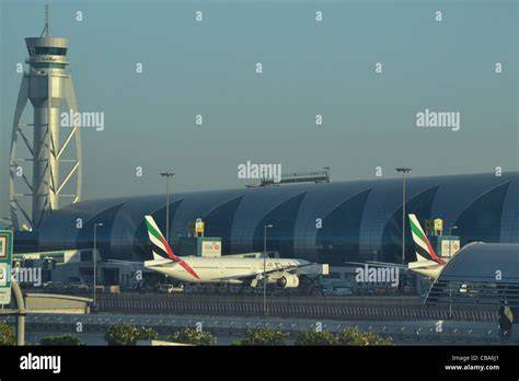 Dubai International Airport control tower and busy aircraft traffic at DXB