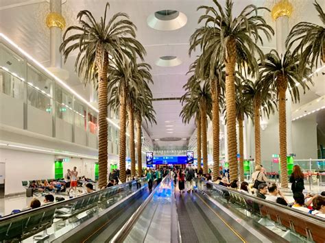 dubai international airport terminal interior with emirates branding