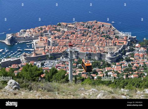 Dubrovnik city lights at night from Mount Srđ with illuminated Old Town below