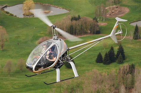 dynali h3 sport light helicopter flying above Belgian countryside