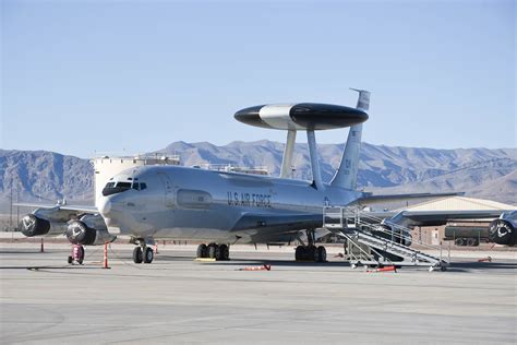 E-3 Sentry parked on tarmac with maintenance crews and support equipment