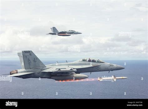 EA-18G Growler firing an AGM-88 HARM missile at a radar target