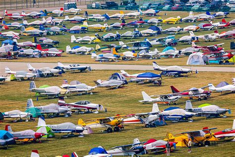 EAA AirVenture volunteers working on site infrastructure near hangars