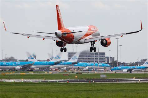 easyJet Airbus A320 at Amsterdam Schiphol Airport with Air France KLM aircraft in the background