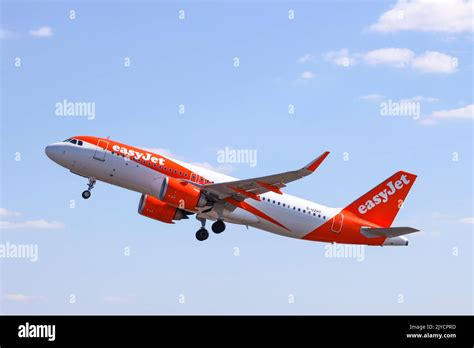 easyJet Airbus A320neo on approach to Amsterdam Schiphol Airport under cloudy skies