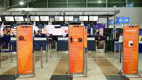 easyJet check-in area with baggage fee signage