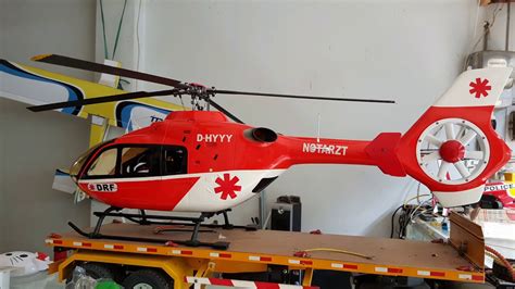 EC135 RC helicopter with Fenestron tail rotor performing simulated rescue mission