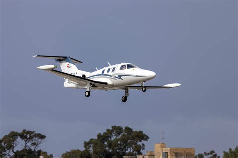 Eclipse 500 private jet taxiing on tarmac in sunrise light