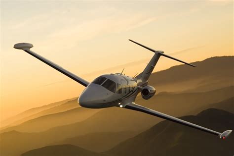 eclipse jet 550 flying over suburban cityscape with sunrise background