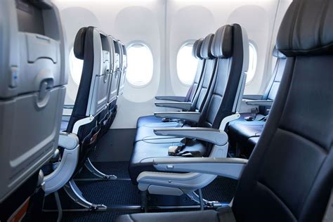economy class 3-3 seating narrowbody jet passengers full cabin perspective