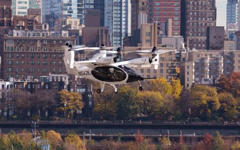 electric air taxi flying over urban skyline near major airport