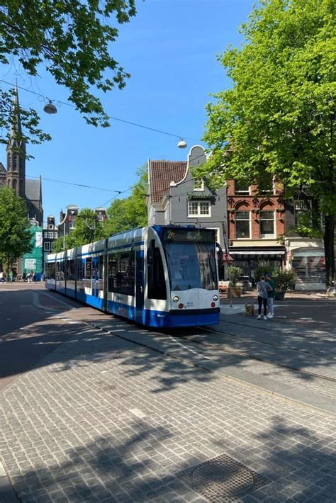 electric gvb tram in amsterdam city center near dam square