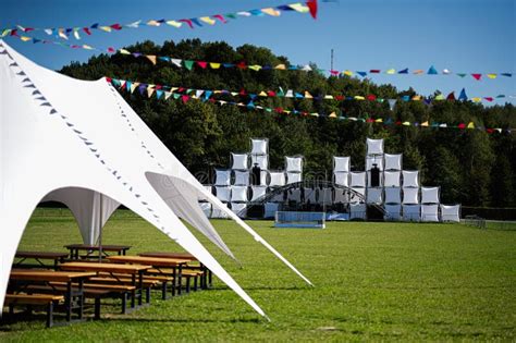 electric picnic festival tents with green fields and rainbow decor
