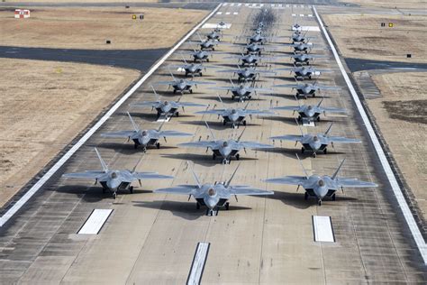 Elmendorf runway with F-22 Raptors and C-17 aircraft in snowy Alaska