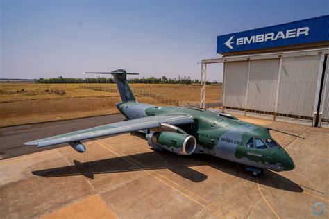 embraer c-390 millennium in flight over rugged terrain