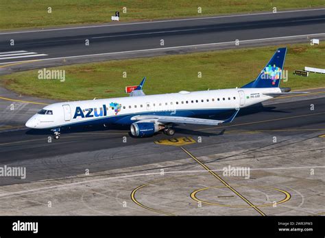 embraer e195-e2 taxiing on runway with vibrant blue and yellow livery
