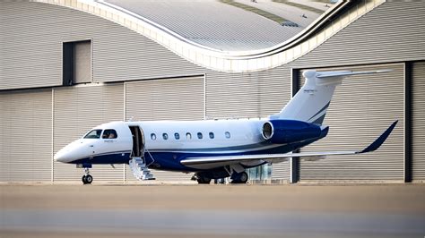 embraer praetor 600 on ramp with luxury livery at sunset