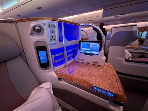 Emirates A380 Business Class cabin interior with mood lighting and personal screens