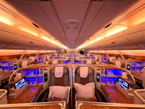 emirates a380 flight attendant serving passengers in business class