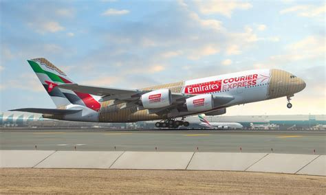 Emirates A380 in flight over desert with visible upper deck windows