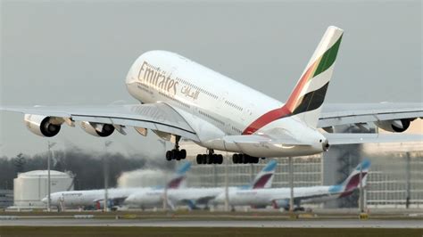 Emirates A380 over Tower Bridge London with sunset backdrop