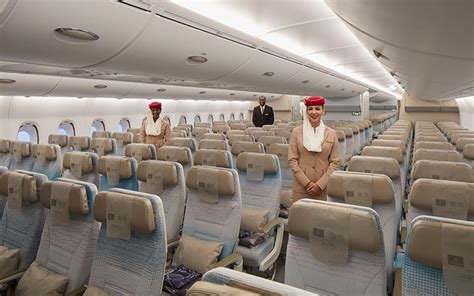 Emirates A380 with cabin crew boarding for international journey under sunset