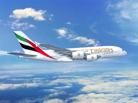 Emirates Airbus A380 flying above Dubai skyline