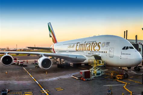emirates airbus a380 parked with maintenance crew at dubai airport