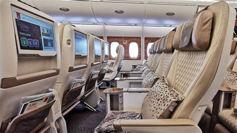 Emirates Airbus A380 premium economy cabin and Dubai International Airport lounge entrance