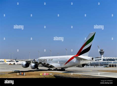 Emirates Airbus A380 taxiing with airport terminal background