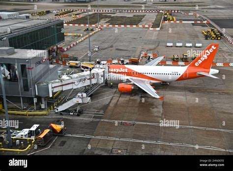 Emirates aircraft at Gatwick Airport terminal during busy travel period