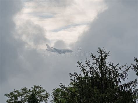 Emirates aircraft flying through high-altitude clouds
