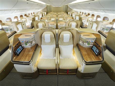 Emirates Boeing 777 business class lie-flat bed setup with bedding
