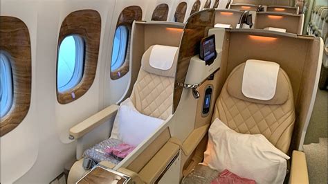 Emirates Boeing 777 business class passenger relaxing during long haul flight