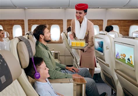Emirates cabin crew member interacting with a child passenger