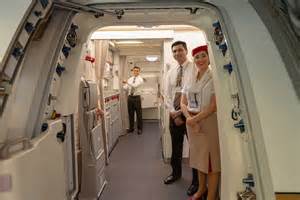 Emirates cabin crew preparing premium cabin aboard Boeing 777-300ER