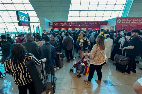 Emirates passengers connecting in Dubai terminal with Asian destination signage