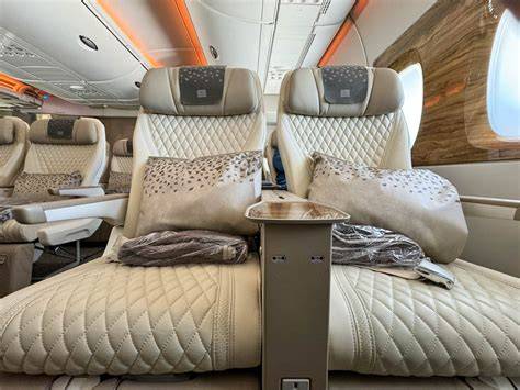 Emirates Premium Economy cream leather seats aboard Airbus A380 with wood-grain cabin accents