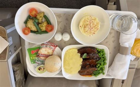 Emirates Premium Economy meal served on fine china with metal cutlery and premium drinks