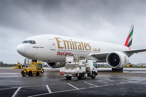 Emirates SkyCargo freighter being loaded at Dubai logistics center at sunset