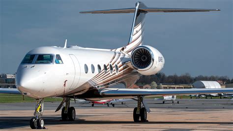 Empty leg private jet parked on airport apron awaiting repositioning flight