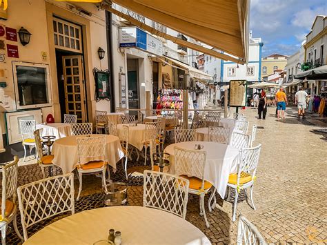 Empty restaurant terraces in Lagos, Algarve during peak summer week