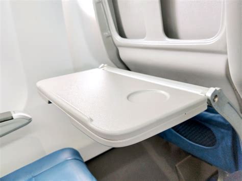empty Wizz Air seat with AYCF card on tray table in economy cabin